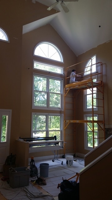 two stories of wallpaper being installed -st. charles