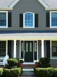 Black front door with dark gray siding