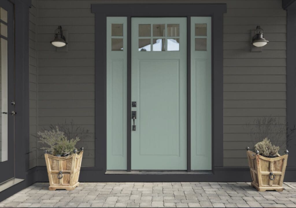 Teal front door with dark gray siding