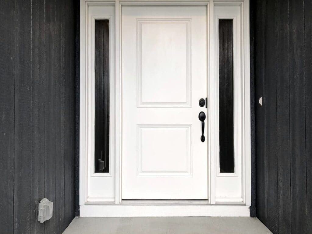 white front door with dark gray siding