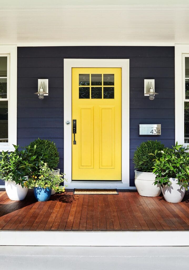 Yellow front door with dark gray siding